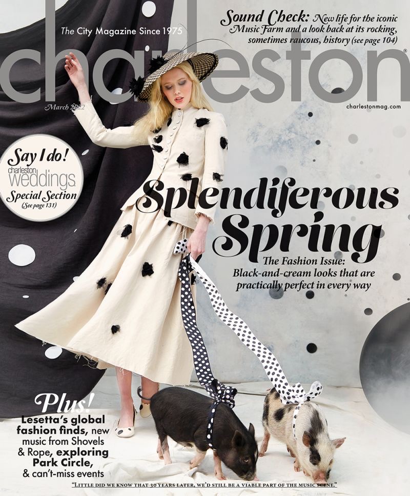 A white woman holding two pigs on a leash on the cover of the March 2022 Charleston Magazine
